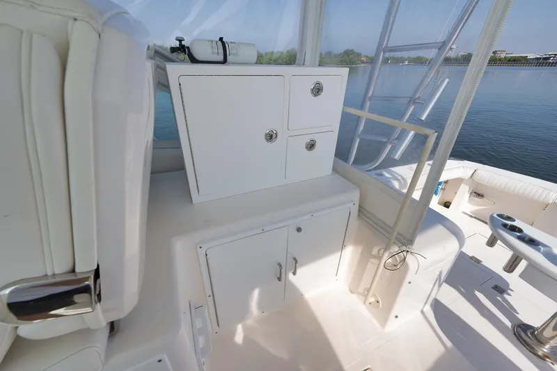 Slide: The Image of 2006 Cabo 32 Express boat interior with storage cabinets and seating area. - 24