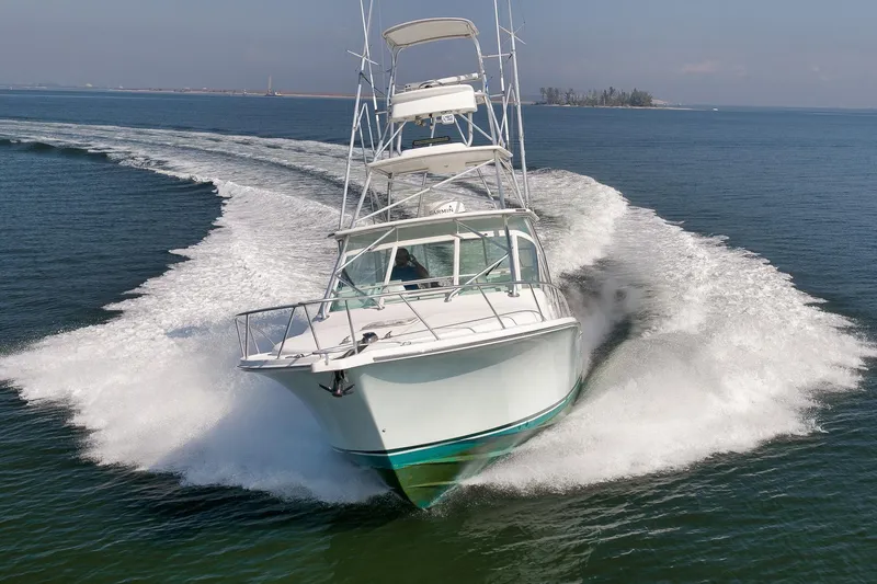 Slide: The Image of 2006 Cabo 32 Express boat cruising swiftly on open water. - 5