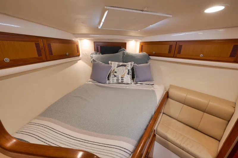 Slide: The Image of Luxurious cabin interior of 2006 Cabo 32 Express yacht with cozy bedding and seating. - 32