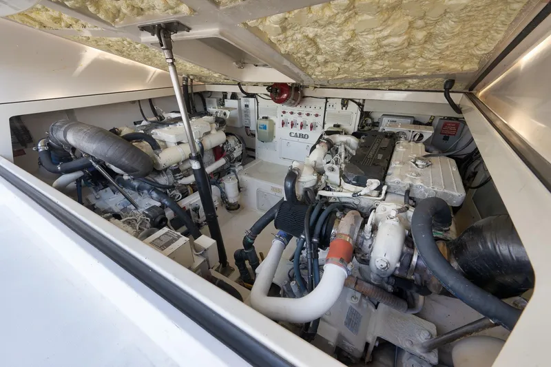 Slide: The Image of Engine room of 2006 Cabo 32 Express boat, showcasing dual engines and mechanical components. - 34