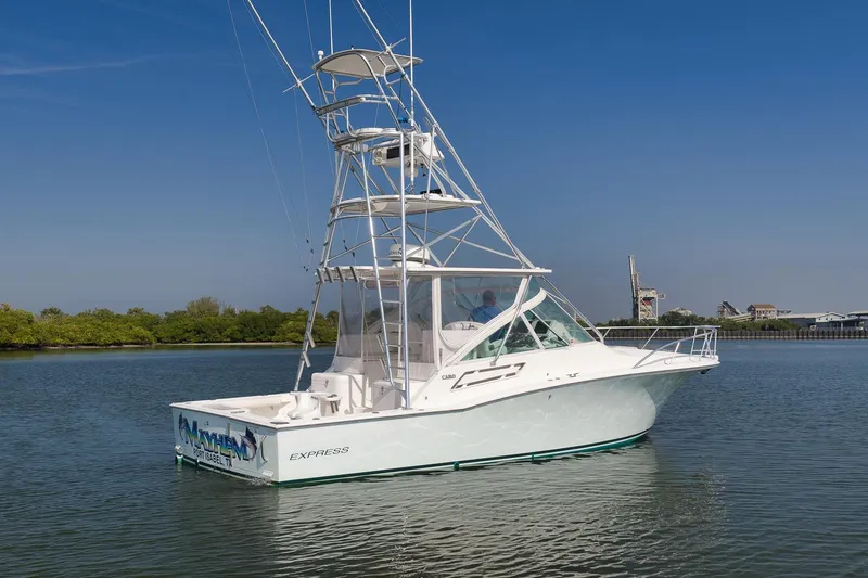 Slide: The Image of 2006 Cabo 32 Express boat on calm water with clear blue sky. - 11