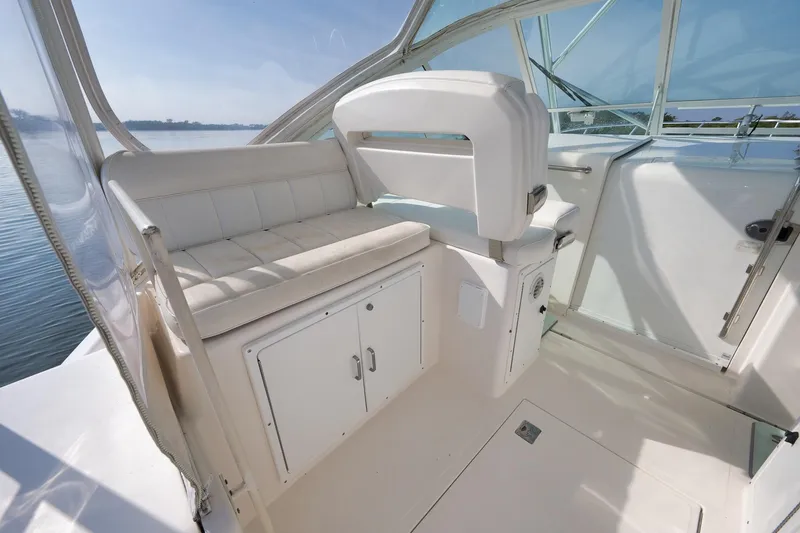 Slide: The Image of 2006 Cabo 32 Express boat interior with white seating and storage compartments. - 21