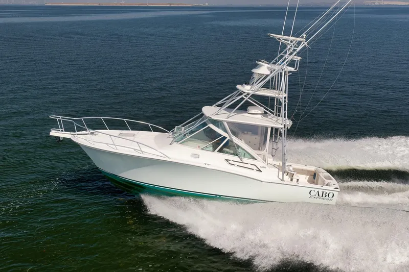 The Image of 2006 Cabo 32 Express boat cruising on open water. - 3