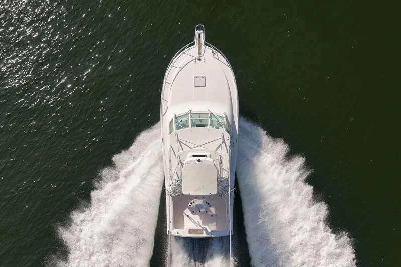 Slide: The Image of Aerial view of 2006 Cabo 32 Express boat cruising on water. - 18