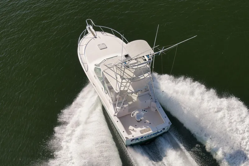 Slide: The Image of Aerial view of 2006 Cabo 32 Express boat cruising on water. - 17