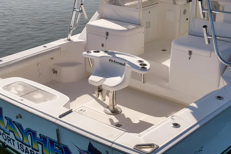 Slide: The Image of 2006 Cabo 32 Express boat deck with fishing chair and storage compartments. - 16