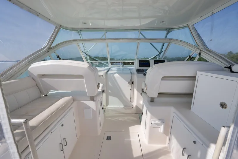Slide: The Image of 2006 Cabo 32 Express boat interior with helm, seating, and navigation equipment. - 19