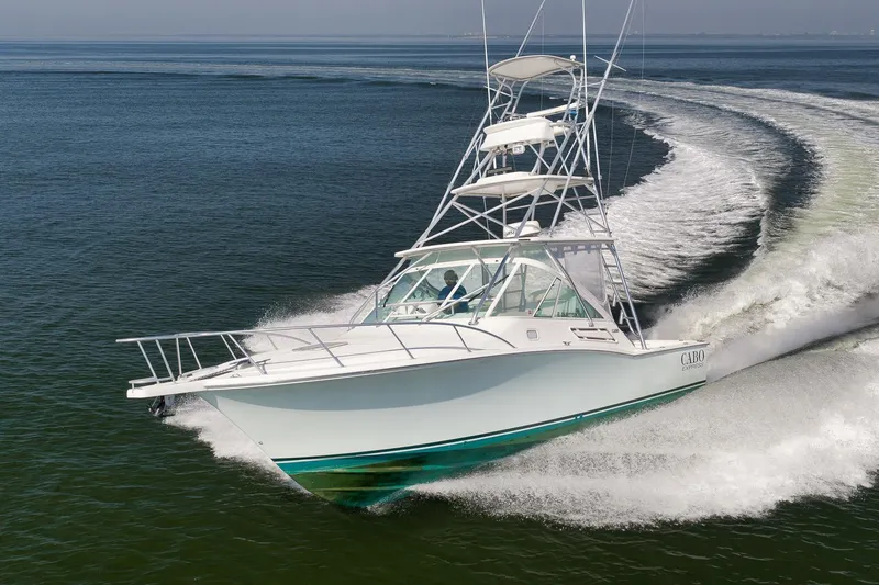 Slide: The Image of 2006 Cabo 32 Express boat cruising swiftly on open water. - 6