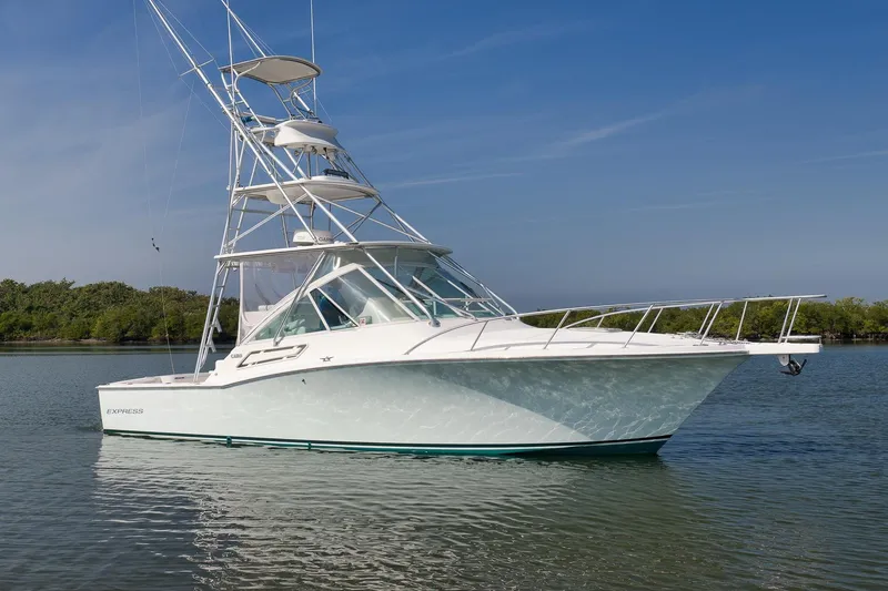 Slide: The Image of 2006 Cabo 32 Express boat on calm water with clear blue sky. - 10