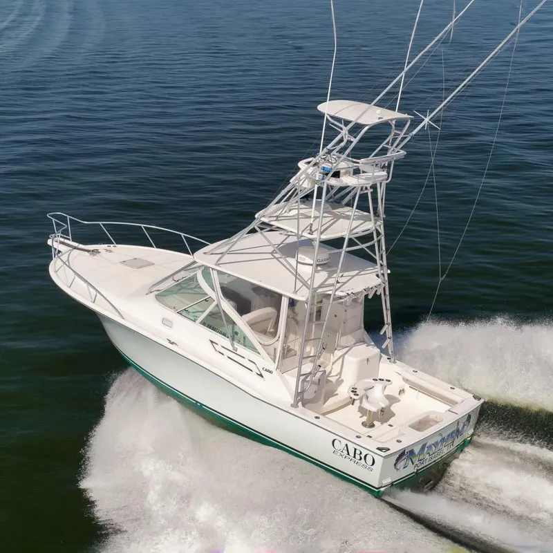 Slide: The Image of 2006 Cabo 32 Express boat cruising on open water, showcasing sleek design and powerful performance. - 2