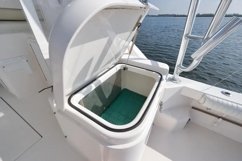 Slide: The Image of Open storage compartment on 2006 Cabo 32 Express boat, with ocean view. - 23