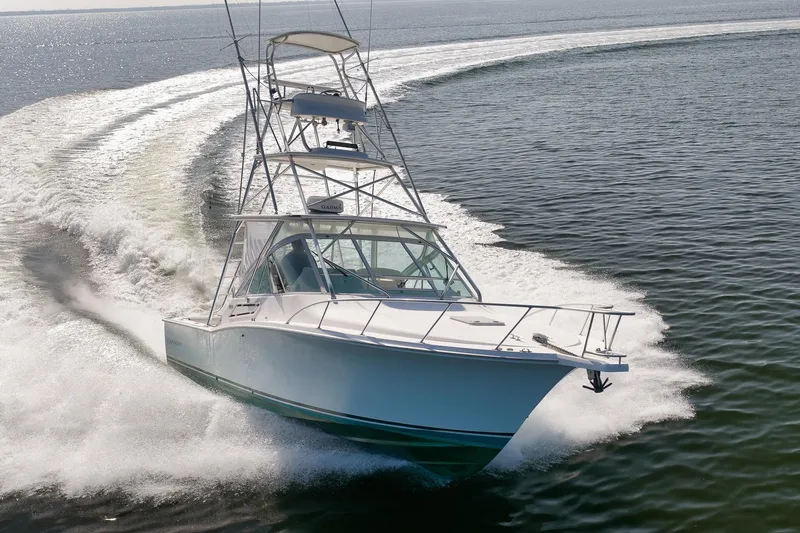 Slide: The Image of 2006 Cabo 32 Express boat cruising swiftly on open water. - 8