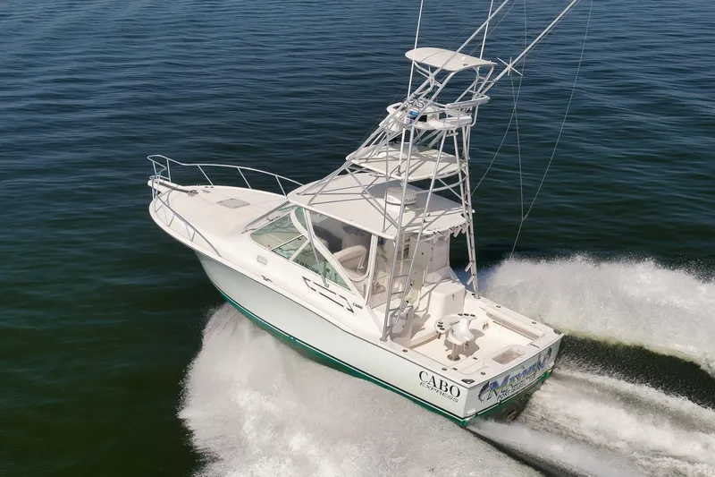 Slide: The Image of 2006 Cabo 32 Express boat cruising on open water, showcasing sleek design and powerful performance. - 4
