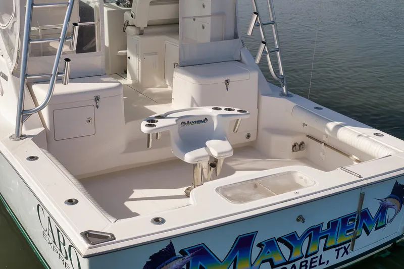 Slide: The Image of 2006 Cabo 32 Express boat deck with fishing chair and storage compartments. - 15