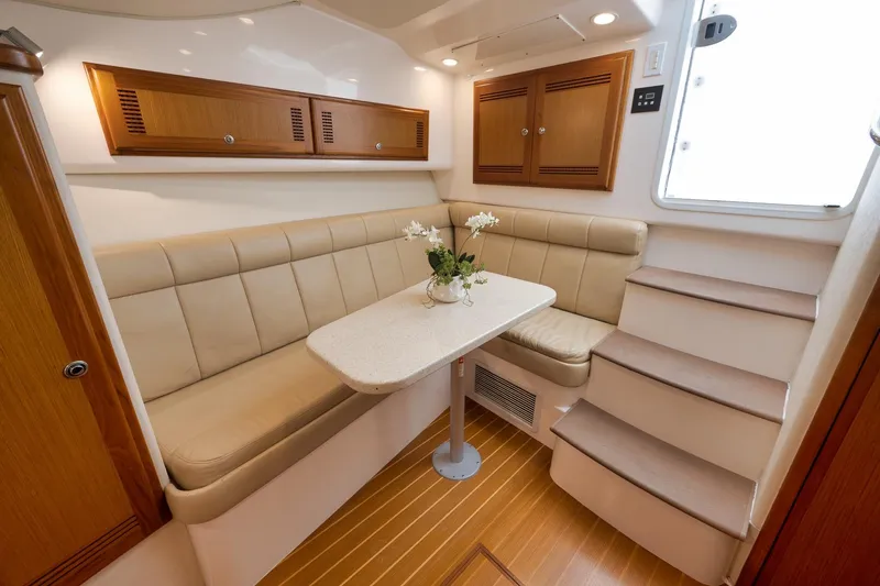 Slide: The Image of Luxurious interior of 2006 Cabo 32 Express yacht with beige seating and wooden accents. - 31