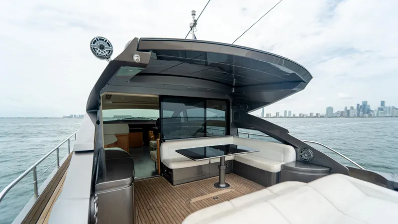 Slide: The Image of 2009 Pershing 64 yacht with sleek deck, city skyline in background. - 11