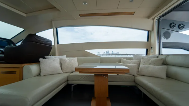Slide: The Image of Luxurious interior of a 2009 Pershing 64 yacht with plush seating and city skyline view. - 19