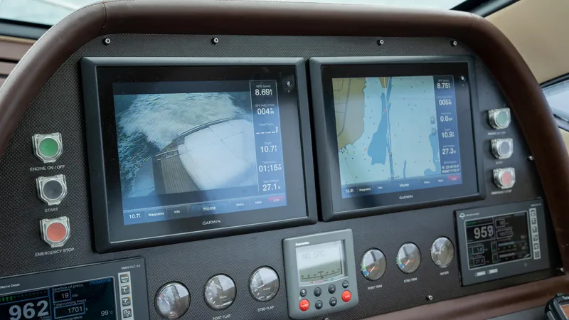 Slide: The Image of Control panel of a 2009 Pershing 64 yacht with navigation screens and gauges. - 23