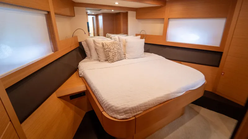 Slide: The Image of Luxurious bedroom interior of 2009 Pershing 64 yacht with modern wood finish. - 27