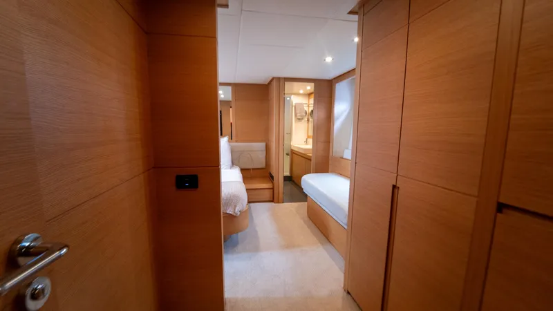 Slide: The Image of Luxurious interior of a 2009 Pershing 64 yacht, featuring wood paneling and modern design. - 28