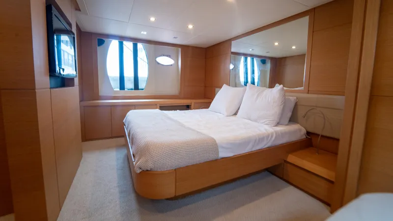 Slide: The Image of Luxurious bedroom interior of 2009 Pershing 64 yacht with modern design and cozy bedding. - 29