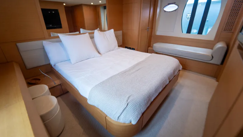 Slide: The Image of Luxurious bedroom interior of 2009 Pershing 64 yacht with modern design and cozy bedding. - 30