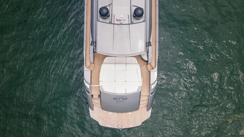 Slide: The Image of Aerial view of 2009 Pershing 64 yacht on water, showcasing sleek design and deck layout. - 5