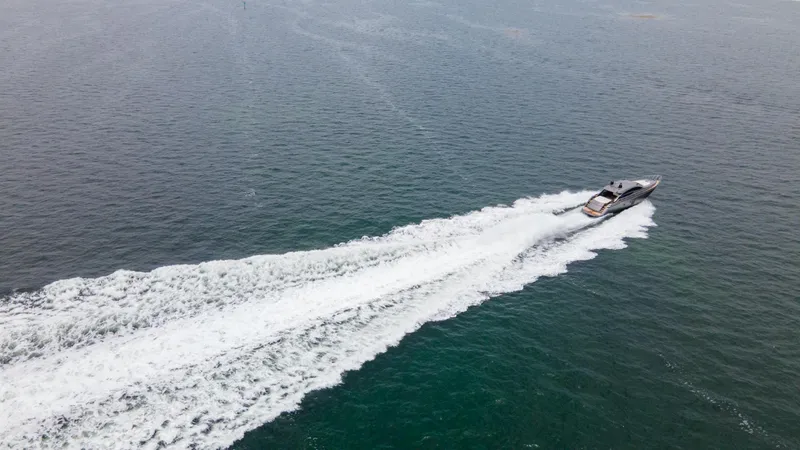 Slide: The Image of Aerial view of 2009 Pershing 64 yacht speeding on open water. - 7