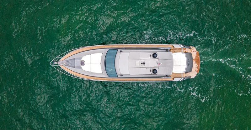 Slide: The Image of Aerial view of 2009 Pershing 64 yacht cruising on green ocean waters. - 9