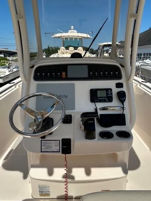 Slide: The Image of 2021 Grady-White Fisherman 216 boat console with steering wheel and navigation equipment. - 10