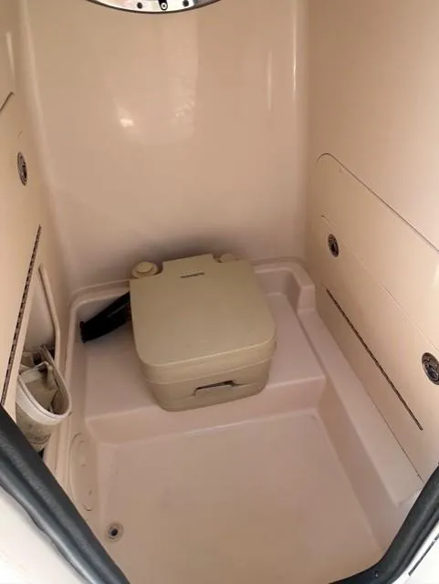 Slide: The Image of Interior of 2021 Grady-White Fisherman 216 boat with portable toilet. - 12