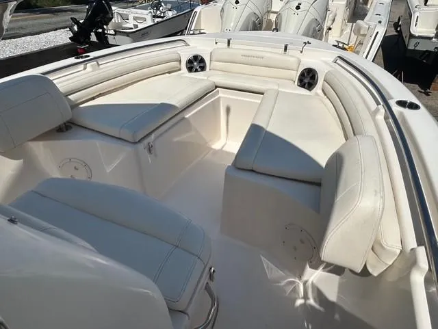 Slide: The Image of 2021 Grady-White Fisherman 216 boat interior with cushioned seating and storage compartments. - 15