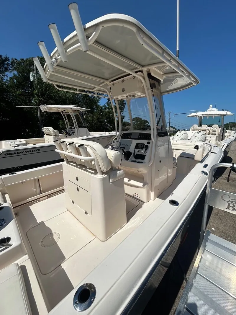 Slide: The Image of 2021 Grady-White Fisherman 216 boat with center console and T-top in a marina. - 5