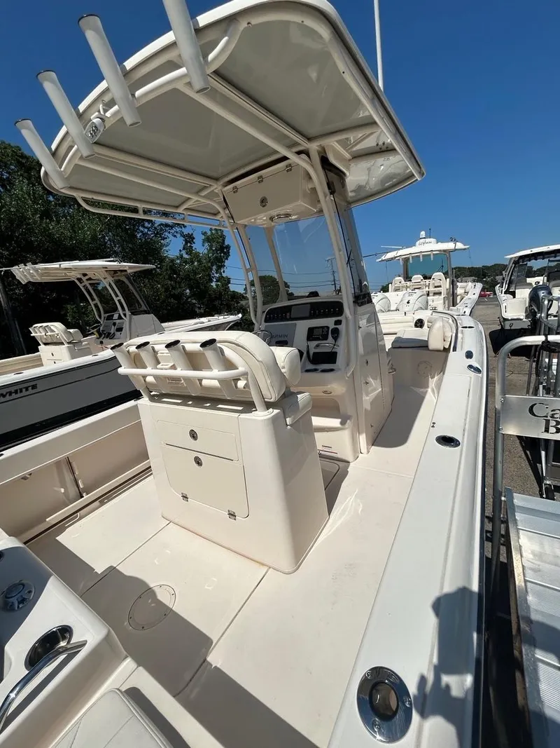 Slide: The Image of 2021 Grady-White Fisherman 216 boat with center console and seating, docked under clear blue sky. - 6