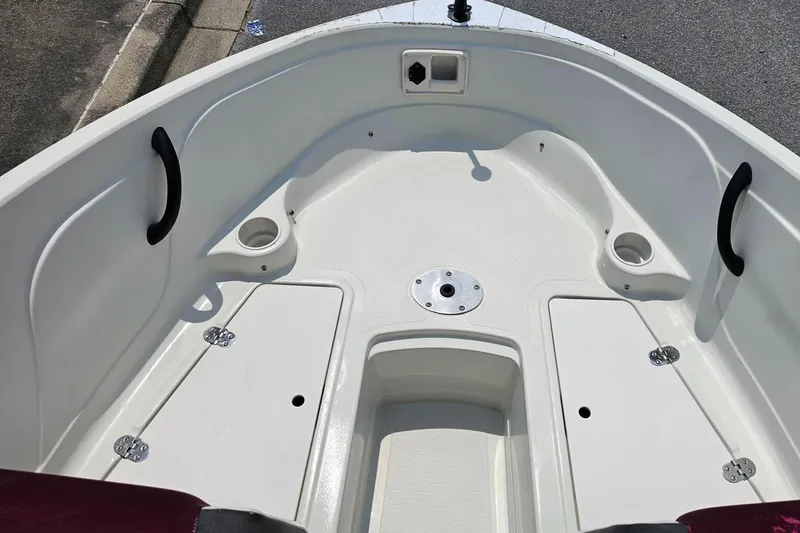 Slide: The Image of 2016 Tahoe 400TF boat interior with storage compartments and cup holders. - 13