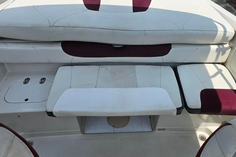 Slide: The Image of 2016 Tahoe 400TF boat interior seating with white and maroon upholstery. - 14