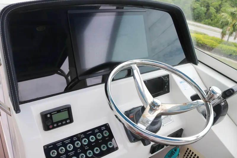 Slide: The Image of Helm of 2017 World Cat 320DC boat with steering wheel and control panel. - 5