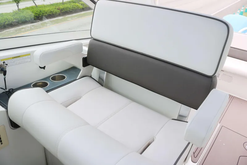 Slide: The Image of 2017 World Cat 320DC boat interior seating with cup holders and armrests. - 6