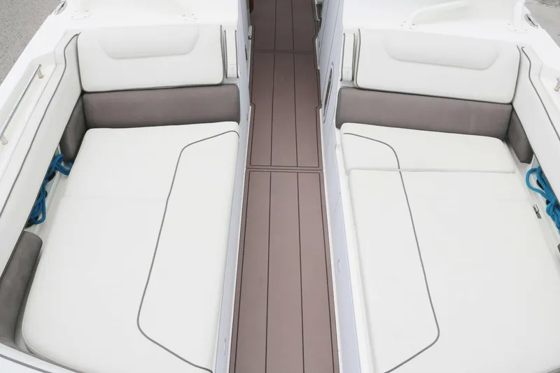 Slide: The Image of 2017 World Cat 320DC boat interior with white cushioned seating and brown flooring. - 8