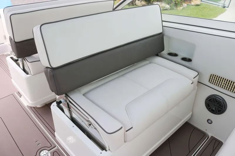 Slide: The Image of 2017 World Cat 320DC boat seating with cup holders and speaker. - 9