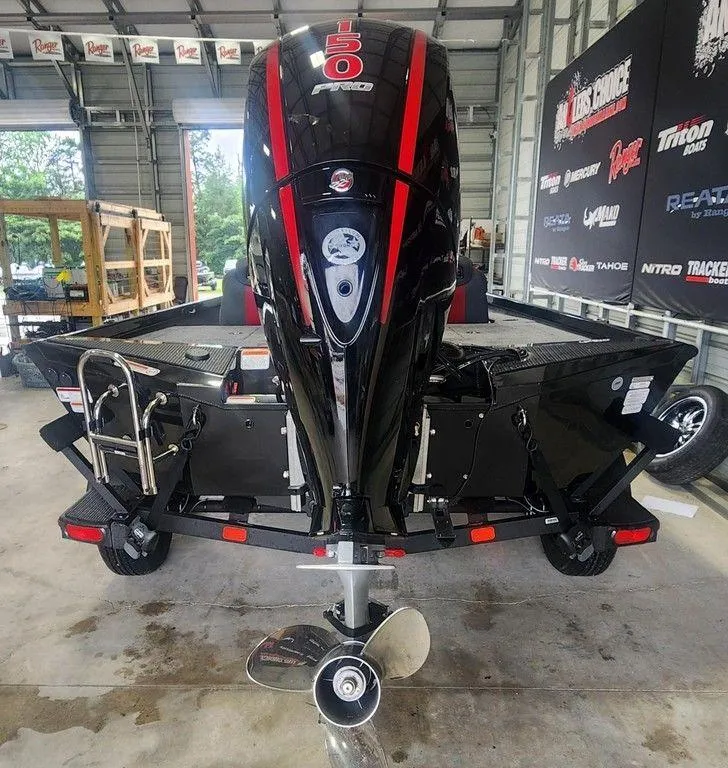 Slide: The Image of 2025 Ranger RT198P boat with powerful 150 Pro engine in a garage setting. - 3