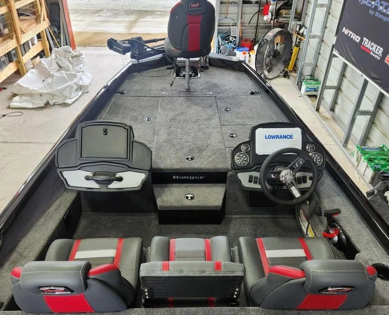 Slide: The Image of 2025 Ranger RT198P boat interior with steering console and seating in a garage setting. - 8