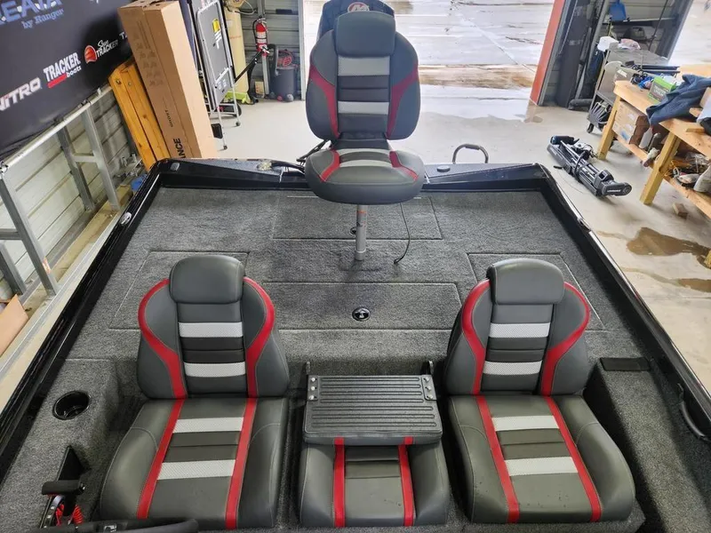 Slide: The Image of 2025 Ranger RT198P boat interior with gray and red seats in a workshop setting. - 9