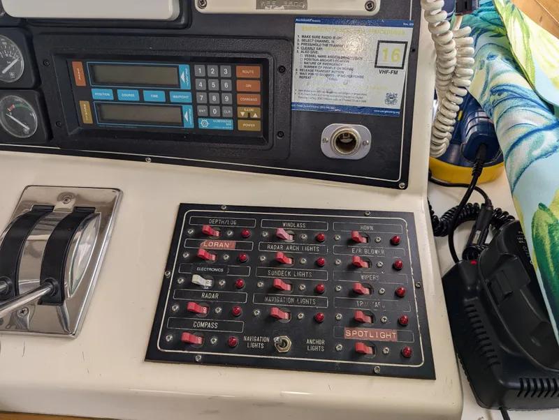 Slide: The Image of Control panel of a 1988 Custom Hi-tech 44 boat with various switches and gauges. - 10