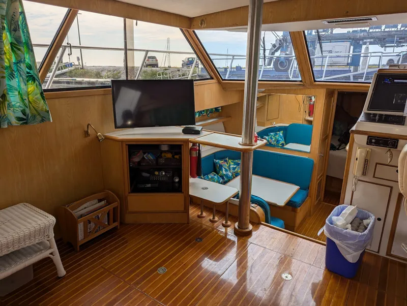 Slide: The Image of Interior of a 1988 Custom Hi-tech 44 boat with wood flooring and modern amenities. - 13