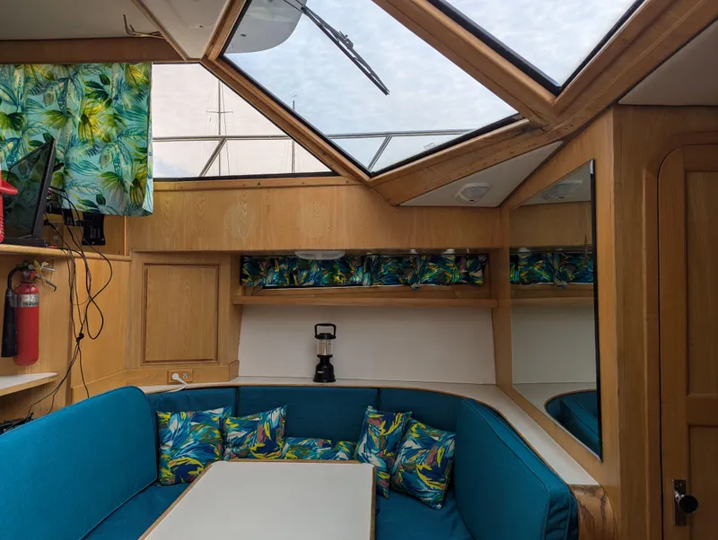 Slide: The Image of Cozy boat interior with skylight, vibrant cushions, and wooden accents, Custom Hi-tech 44, 1988. - 15