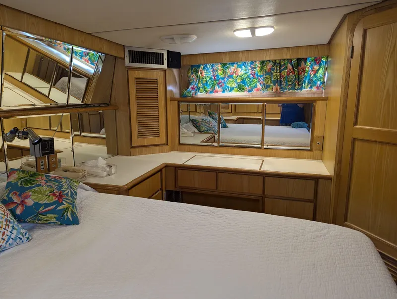 Slide: The Image of Cozy bedroom with floral curtains, mirrored walls, and wooden cabinetry in a 1988 Custom Hi-tech 44. - 22