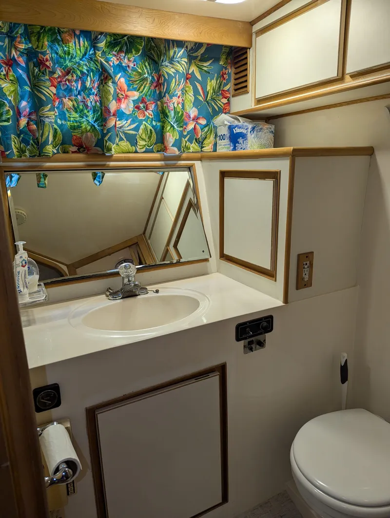 Slide: The Image of Compact 1988 Custom Hi-tech 44 bathroom with floral curtains, sink, and toilet. - 26