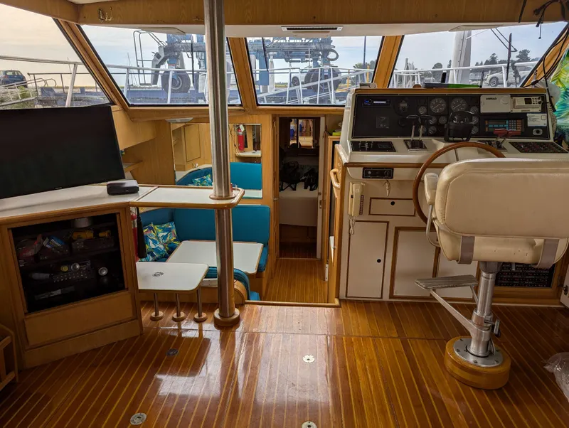 Slide: The Image of Interior of a 1988 Custom Hi-tech 44 boat with wooden flooring and control panel. - 8