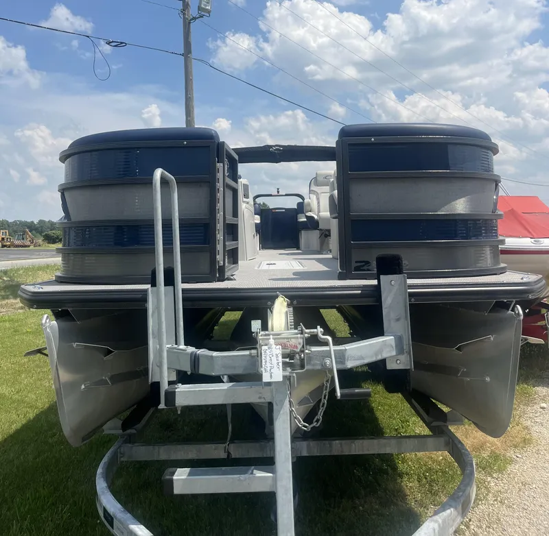 Slide: The Image of 2022 Crest Caribbean LX 250 CP3 pontoon boat on trailer under a cloudy sky. - 3